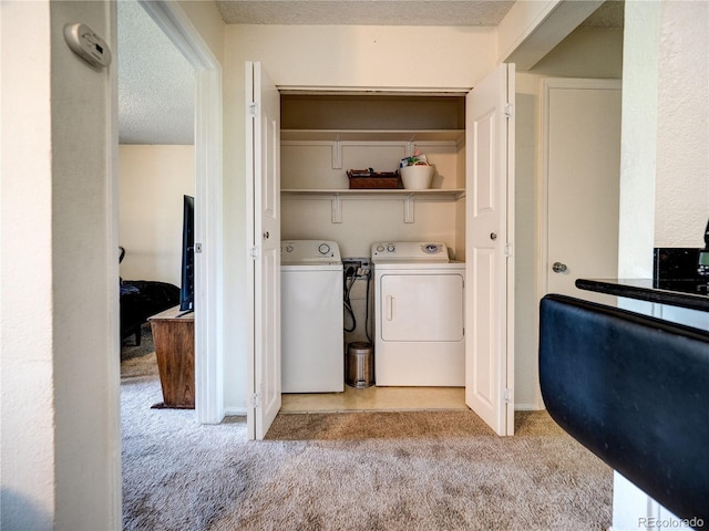14590 E 2nd Ave Unit 105B, Aurora, CO 80011 - laundry area featuring carpet, separate washer and dryer, and a textured ceiling