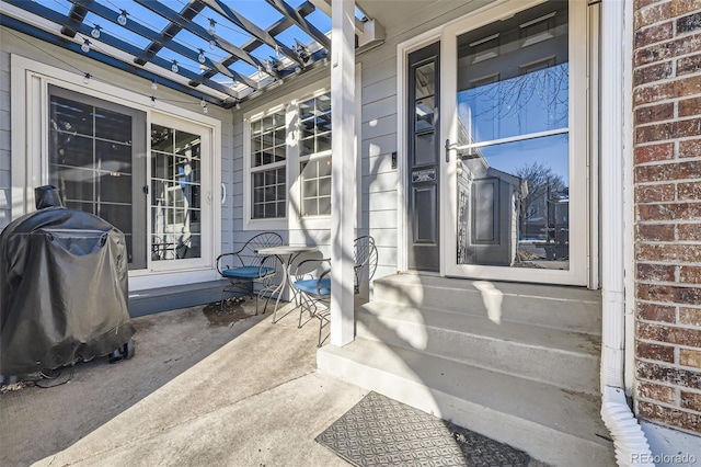 property entrance with a pergola