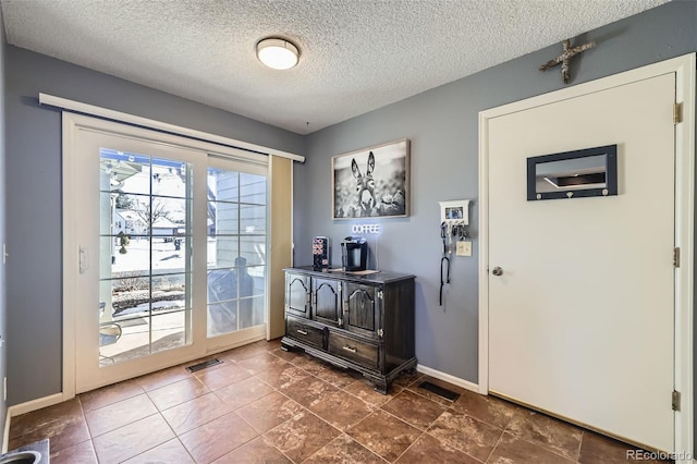 entryway featuring a textured ceiling