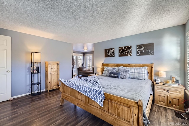 bedroom featuring dark wood-type flooring and a textured ceiling