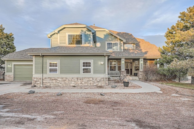 view of front facade featuring a porch and a garage