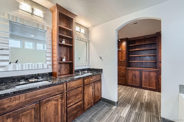 bathroom featuring vanity and a textured ceiling