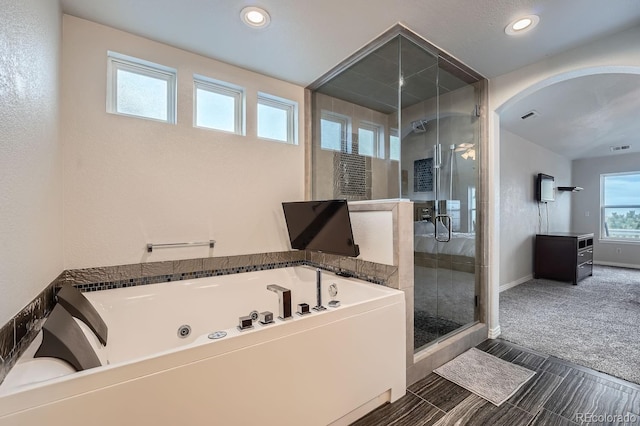 bathroom with shower with separate bathtub