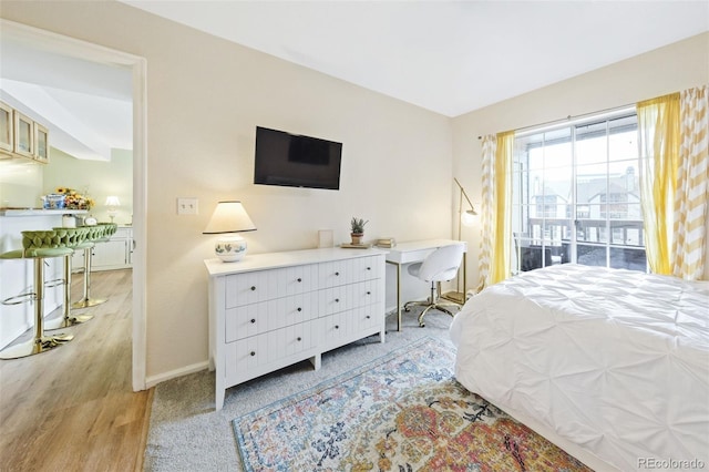 bedroom featuring light wood-style flooring and baseboards