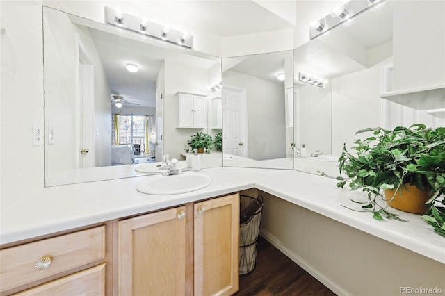 bathroom featuring ceiling fan, wood finished floors, connected bathroom, and vanity