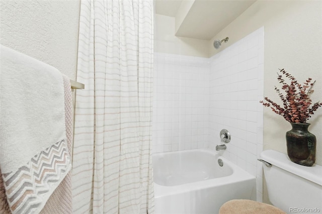 bathroom with tub / shower combination and toilet