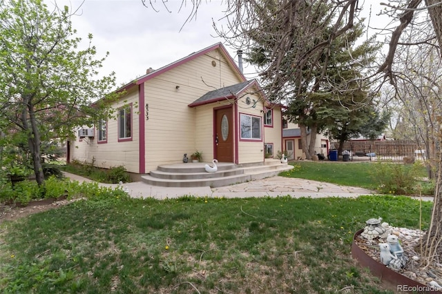 rear view of house with a lawn