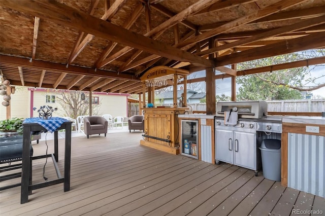 deck with a grill, sink, wine cooler, and exterior kitchen