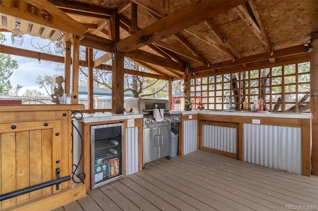 exterior space with wine cooler and an outdoor kitchen