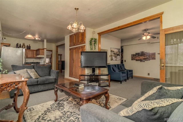 carpeted living room with ceiling fan with notable chandelier