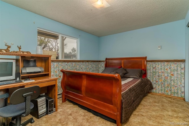 bedroom featuring light carpet and a textured ceiling