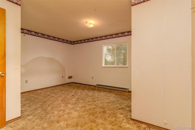 spare room with a baseboard radiator, a textured ceiling, and carpet floors