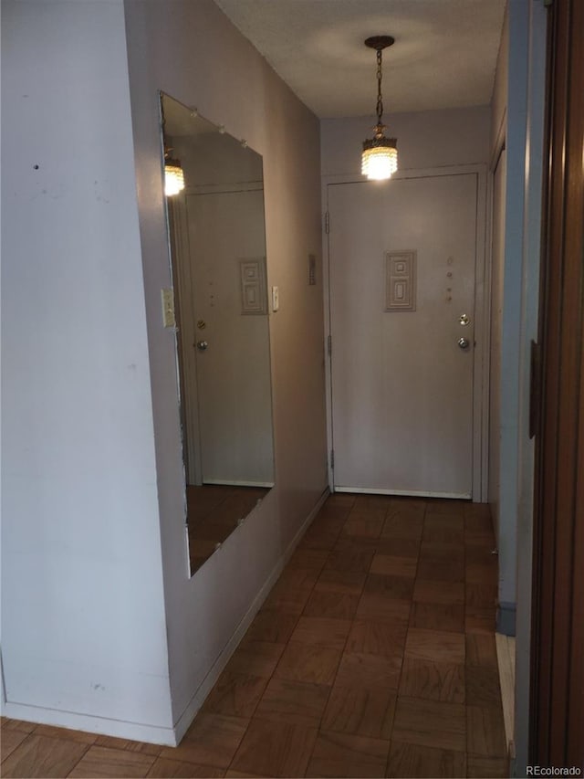 corridor with dark parquet flooring