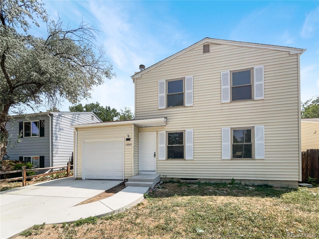 view of front of home featuring a garage and a front lawn