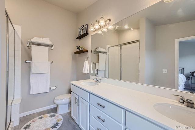 bathroom with toilet, vanity, and walk in shower