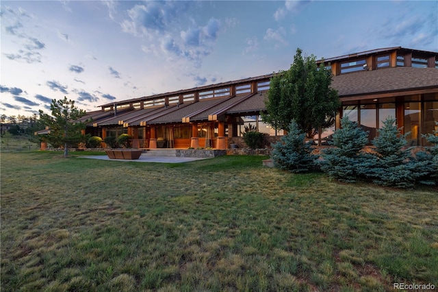 6455 Dakota Ridge Dr, Golden, CO 80403 - rear view of property featuring a lawn and a patio