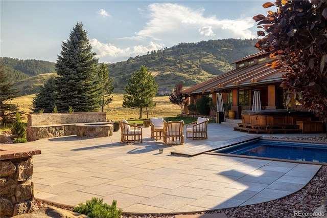 6455 Dakota Ridge Dr, Golden, CO 80403 - outdoor pool with an outdoor fire pit, a mountain view, a hot tub, and a patio area