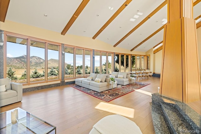 6455 Dakota Ridge Dr, Golden, CO 80403 - living room featuring a mountain view, high vaulted ceiling, wood finished floors, and beamed ceiling