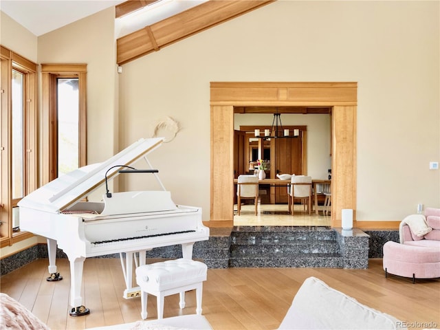 6455 Dakota Ridge Dr, Golden, CO 80403 - sitting room with lofted ceiling, wood finished floors, and a chandelier