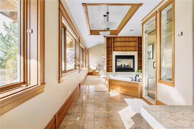6455 Dakota Ridge Dr, Golden, CO 80403 - hall with healthy amount of natural light, a tray ceiling, light marble finish floors, and baseboards