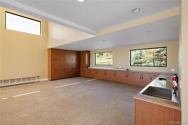 6455 Dakota Ridge Dr, Golden, CO 80403 - kitchen featuring a sink, light carpet, recessed lighting, and brown cabinets