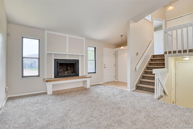 1419 Territory Trl, Colorado Springs, CO 80919 - unfurnished living room featuring carpet flooring, stairway, a fireplace with raised hearth, and baseboards