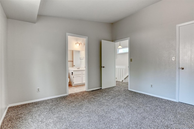 1419 Territory Trl, Colorado Springs, CO 80919 - unfurnished bedroom with light carpet, baseboards, and connected bathroom