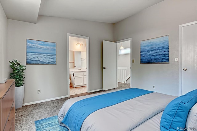1419 Territory Trl, Colorado Springs, CO 80919 - bedroom with light colored carpet, ensuite bath, and baseboards