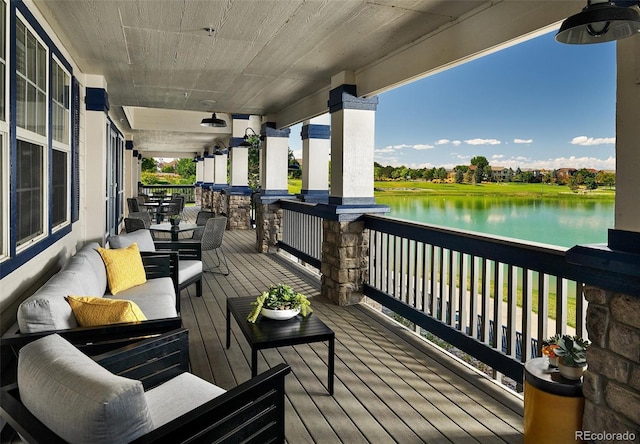 wooden deck with a water view and an outdoor hangout area