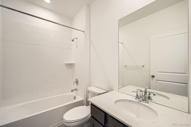 bathroom featuring toilet, washtub / shower combination, and vanity