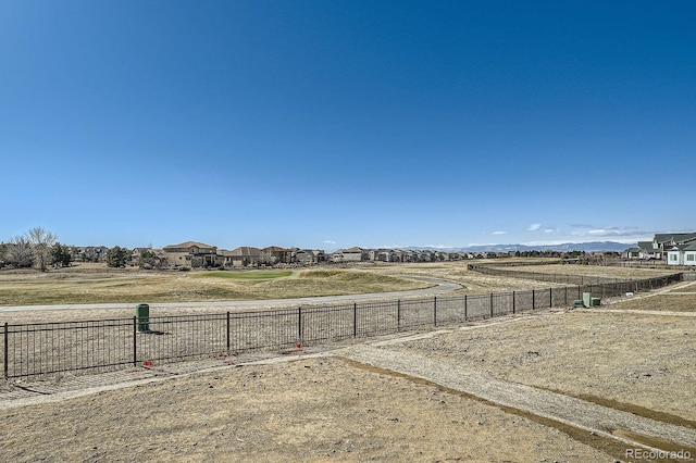 view of yard with a residential view and fence