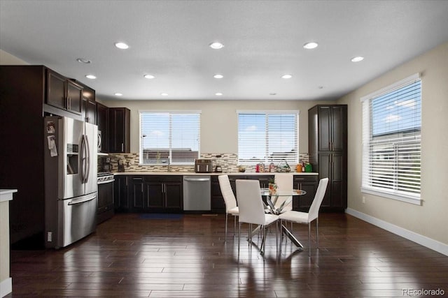 2521 Moline St, Aurora, CO 80010 - kitchen featuring appliances with stainless steel finishes, backsplash, recessed lighting, baseboards, and light countertops