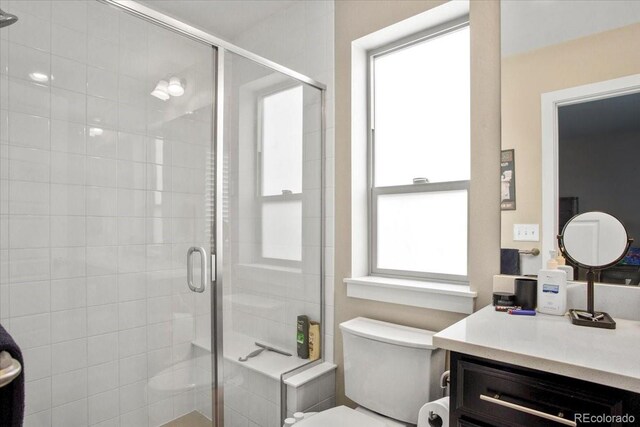 2521 Moline St, Aurora, CO 80010 - bathroom featuring a shower stall, toilet, and vanity