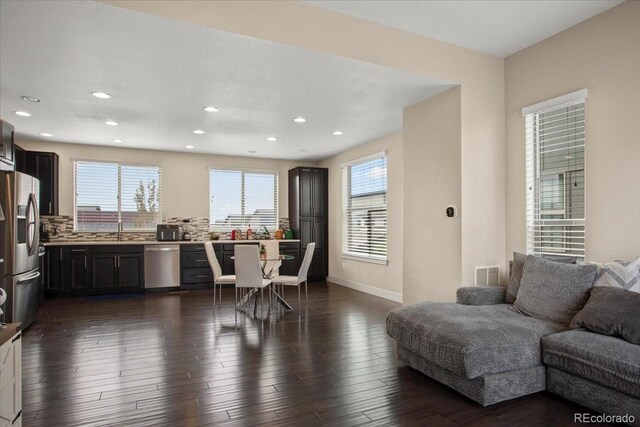 2521 Moline St, Aurora, CO 80010 - kitchen with stainless steel appliances, open floor plan, recessed lighting, light countertops, and dark wood-style floors