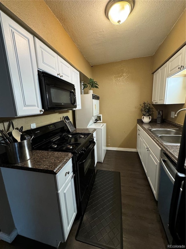 kitchen with washer and dryer, white cabinets, black appliances, dark hardwood / wood-style flooring, and sink