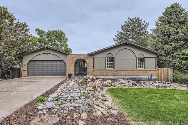 1010 Ash St, Broomfield, CO 80020 - single story home with brick siding, driveway, a garage, and stucco siding