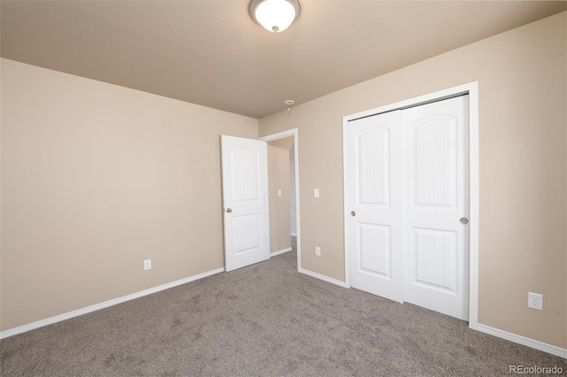 unfurnished bedroom with carpet floors and a closet