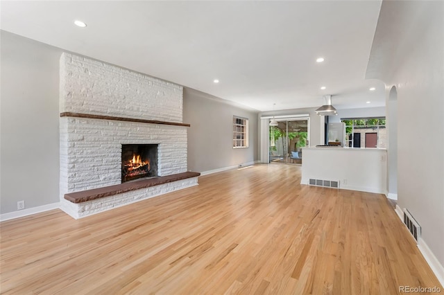 1579 Fairfax St, Denver, CO 80220 - unfurnished living room featuring a large fireplace, light wood-style floors, and recessed lighting