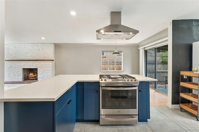 1579 Fairfax St, Denver, CO 80220 - kitchen with stainless steel gas range oven, exhaust hood, blue cabinets, light countertops, and recessed lighting