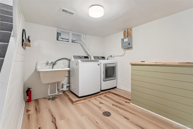 1579 Fairfax St, Denver, CO 80220 - laundry room with separate washer and dryer, light wood-style flooring, and electric panel