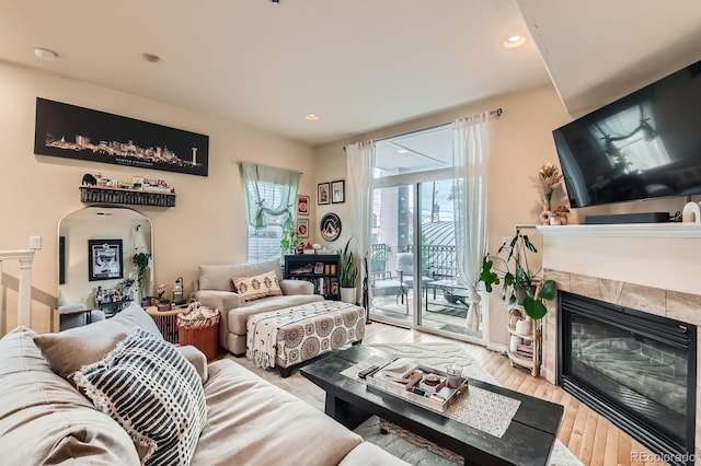 3030 Wyandot St Unit 7, Denver, CO 80211 - living area featuring a tiled fireplace, arched walkways, light wood-style flooring, and recessed lighting