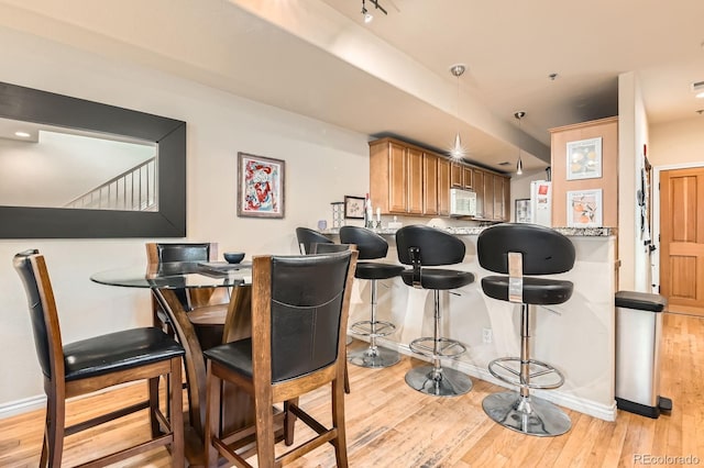 3030 Wyandot St Unit 7, Denver, CO 80211 - dining area featuring light wood-type flooring and stairway