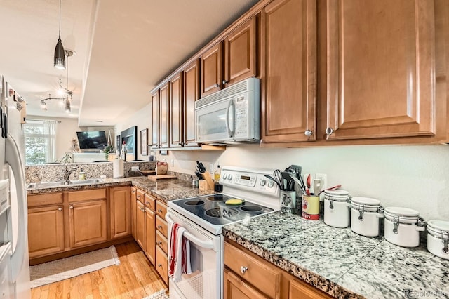 3030 Wyandot St Unit 7, Denver, CO 80211 - kitchen with white appliances, light wood finished floors, brown cabinetry, and tile countertops