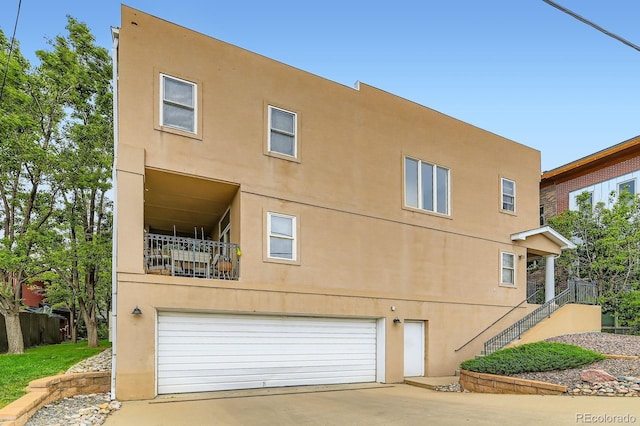 3030 Wyandot St Unit 7, Denver, CO 80211 - back of property with an attached garage, stucco siding, and concrete driveway