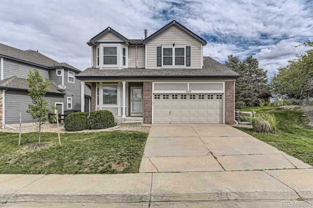 view of property featuring a garage and a front lawn