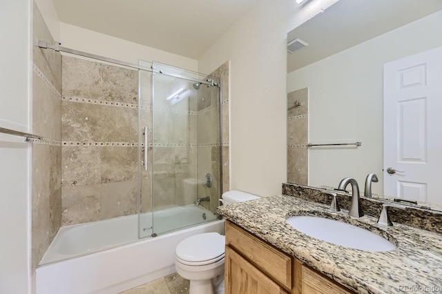 full bathroom with tile patterned floors, shower / bath combination with glass door, vanity, and toilet