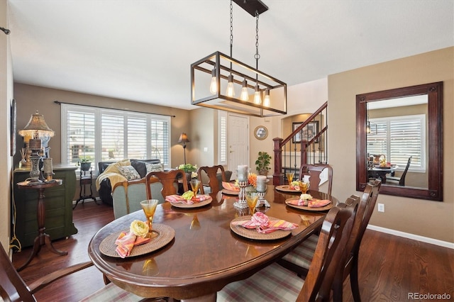 dining space with a healthy amount of sunlight, baseboards, stairway, and wood finished floors