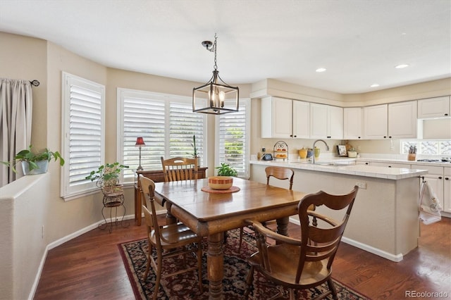 dining area with baseboards, recessed lighting, dark wood-style flooring, and an inviting chandelier