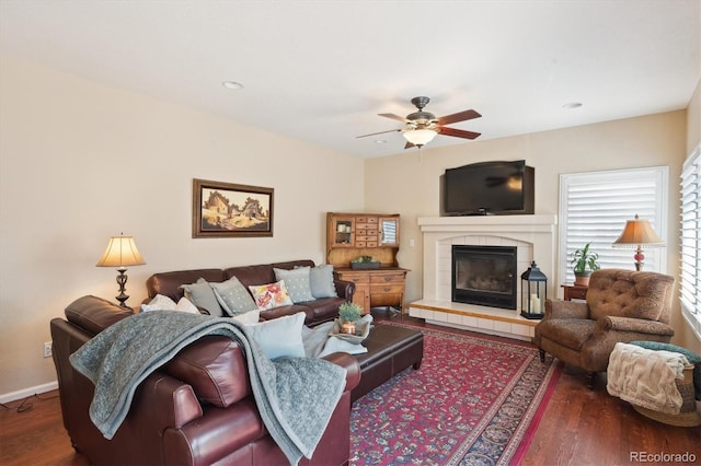 living area featuring ceiling fan, a tiled fireplace, recessed lighting, baseboards, and wood finished floors