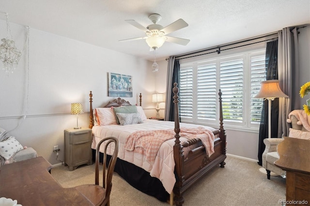 bedroom with a ceiling fan, baseboards, and light carpet